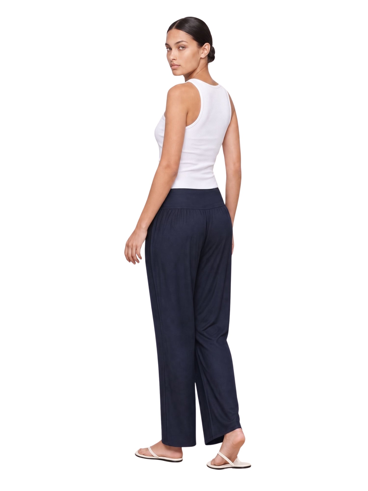 Woman in navy wide-leg lounge pants with white tank top, ideal for travel and everyday comfort.