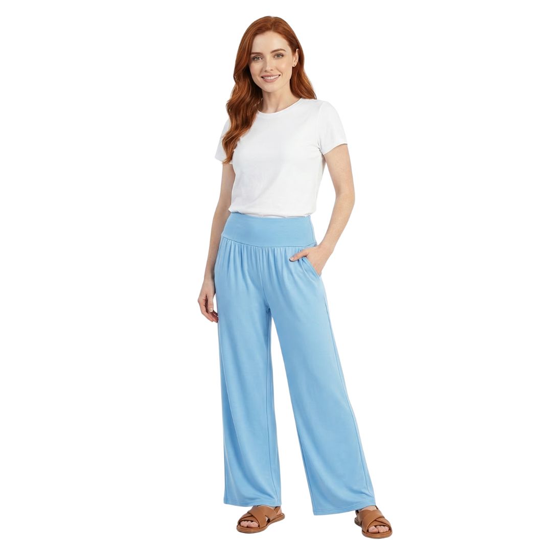 Woman wearing light blue wide-leg lounge pants with elastic waist, ideal for travel and home comfort.