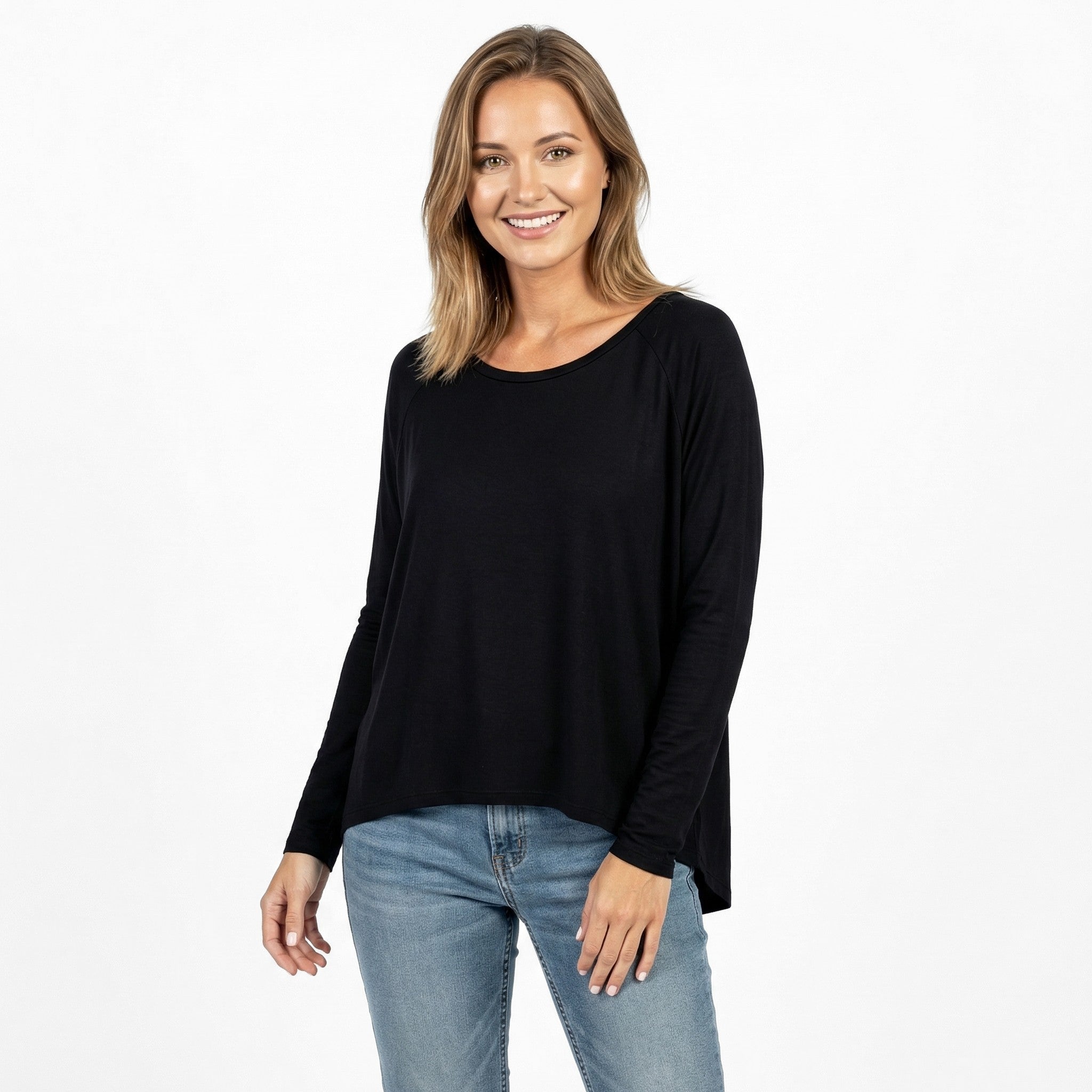 Woman wearing black long sleeve travel top with relaxed fit, ideal for comfort on flights or daily wear