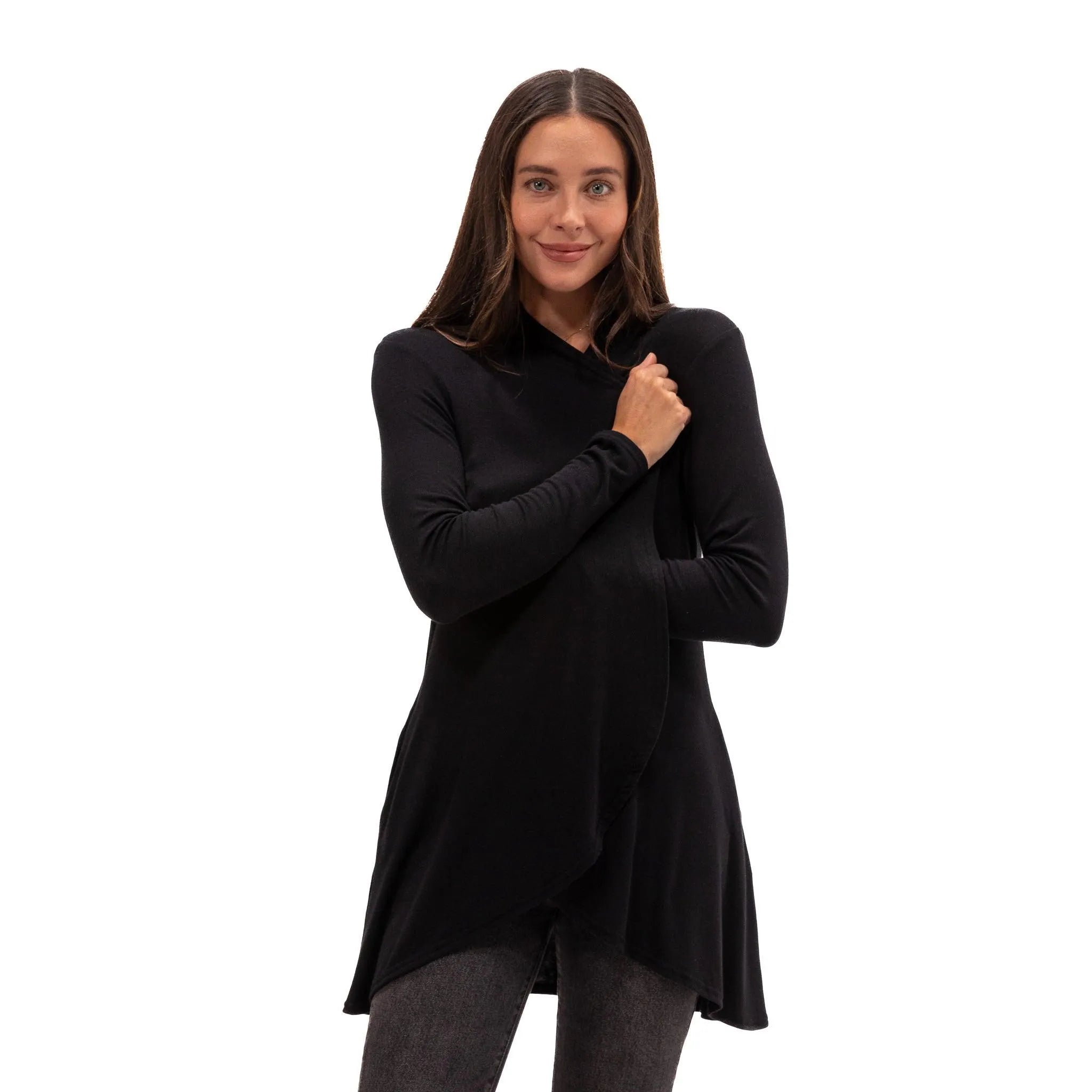 Woman wearing soft black long-sleeve travel top with asymmetrical hem, ideal for flights and everyday comfort.
