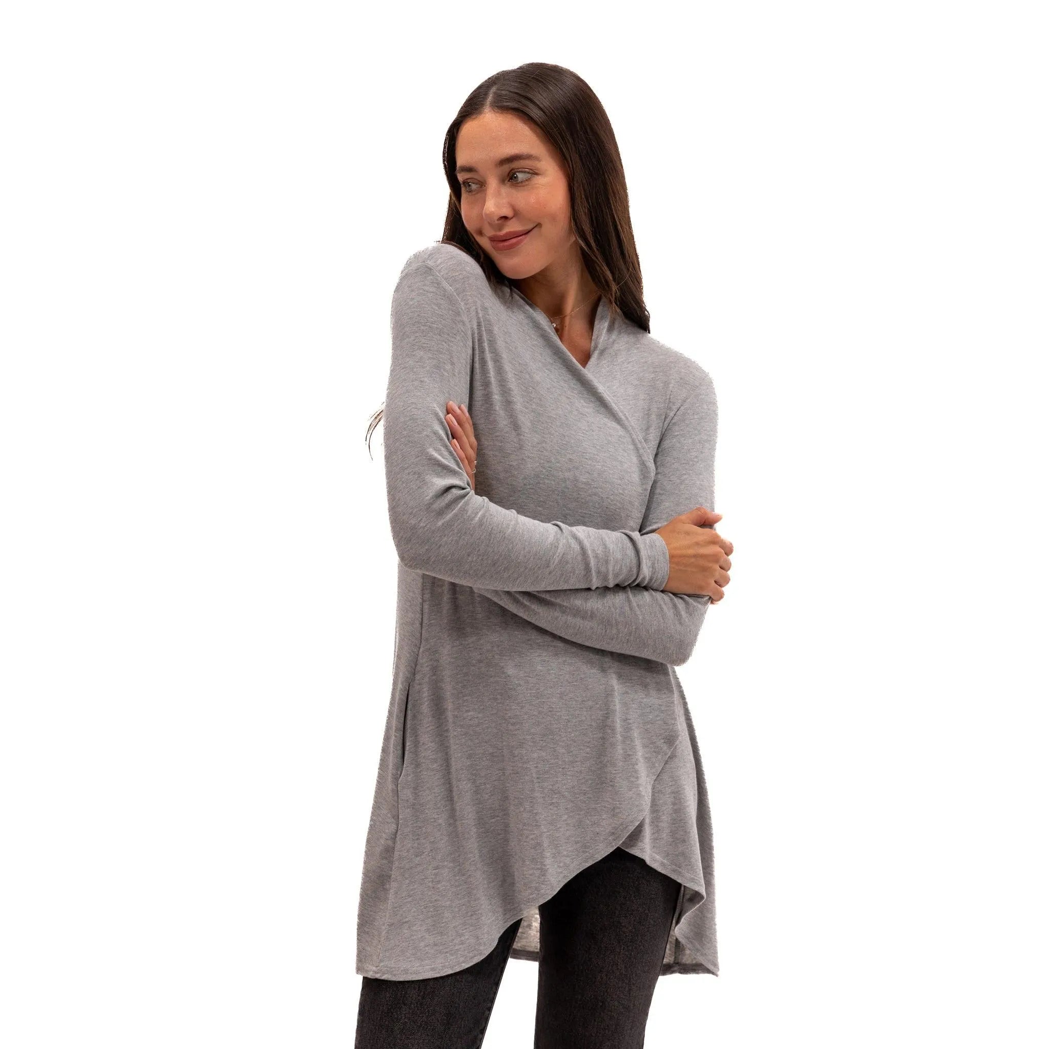 Woman wearing cozy gray wrap tunic top for travel or lounging, soft sustainable fabric