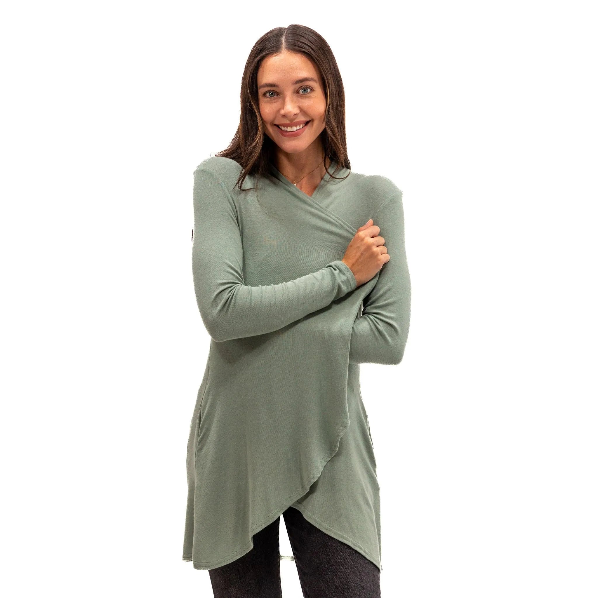 Woman wearing soft sage green long sleeve wrap top, ideal for travel and everyday comfort.