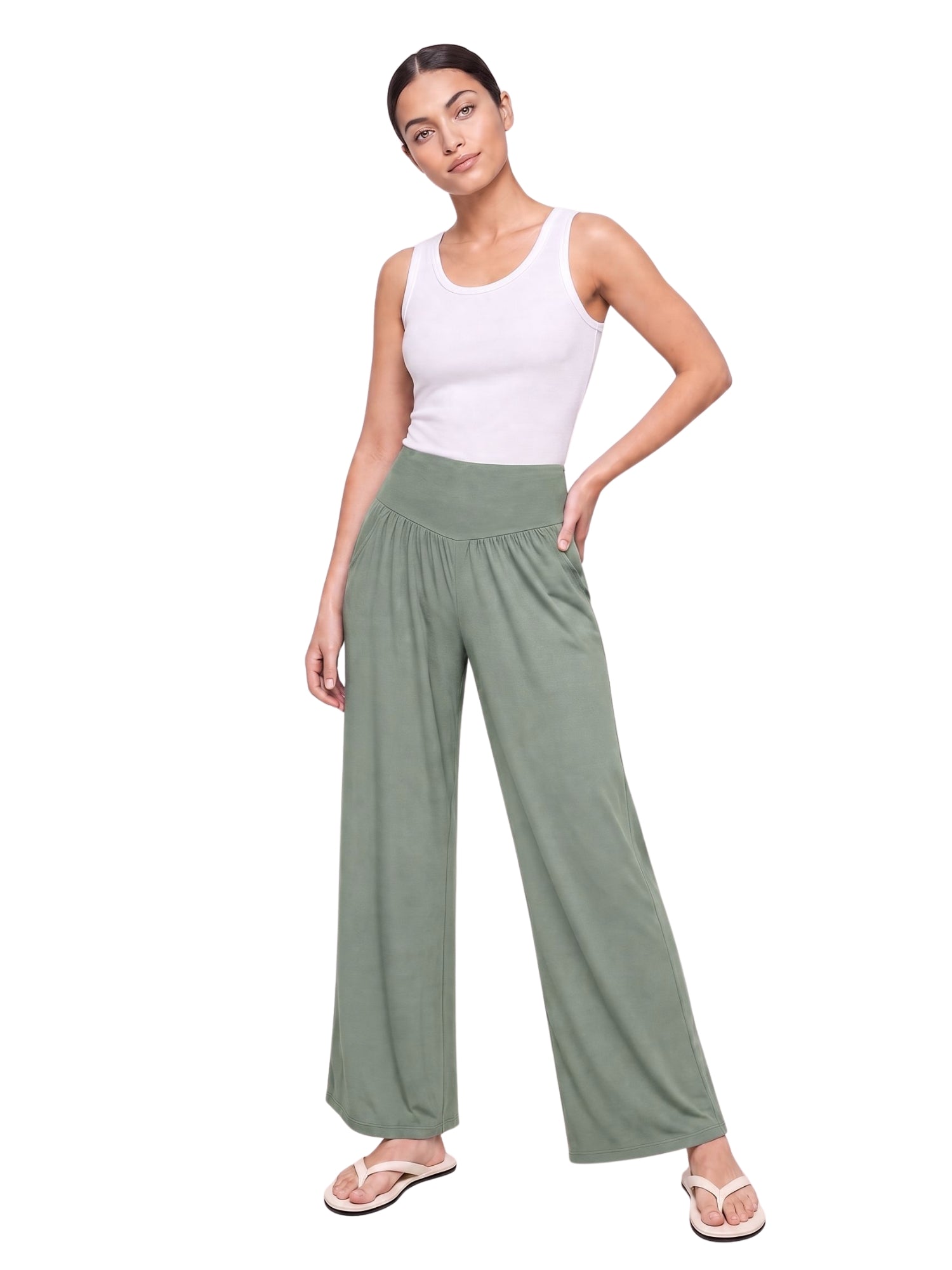 Woman wearing olive green wide-leg lounge pants with elastic waist, ideal for travel and everyday comfort.