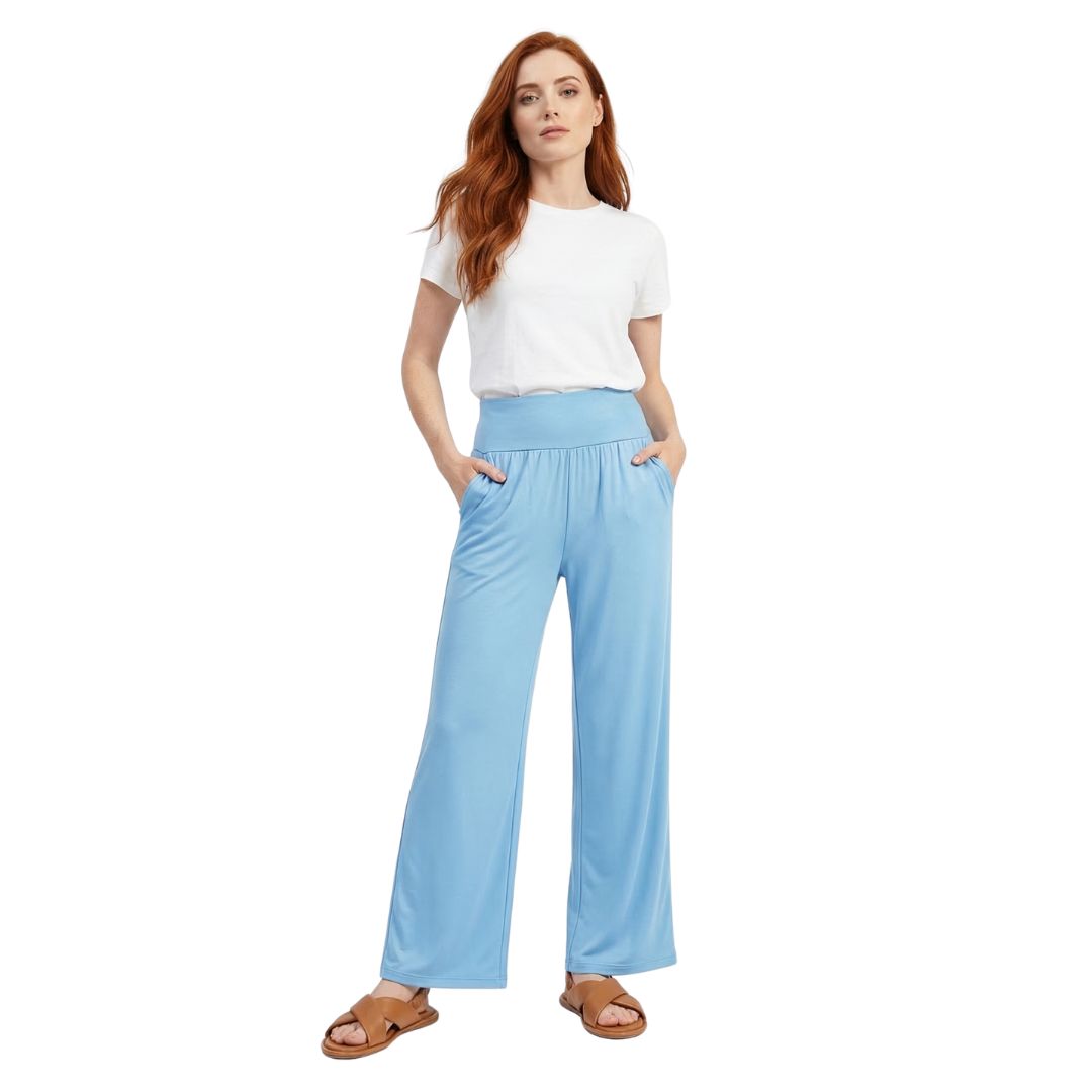 Woman wearing light blue wide-leg lounge pants with pockets, paired with white tee and sandals